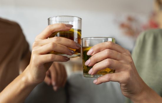 Picture of two hands holding drinks